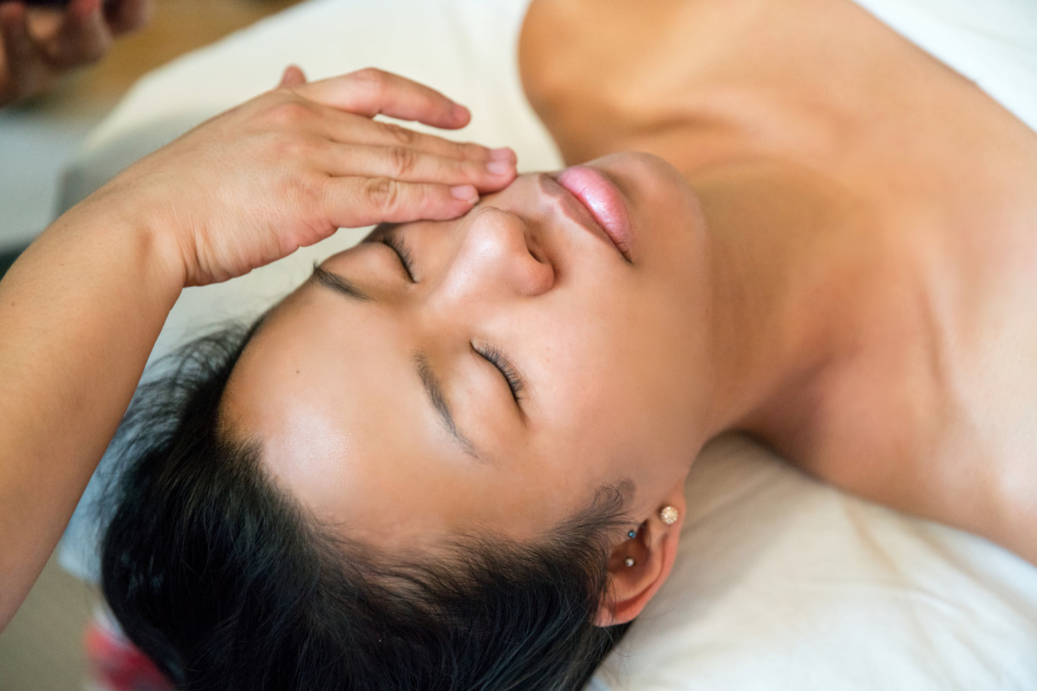 a women Applying face mask to another women's face